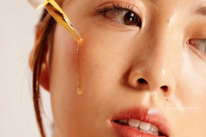 science pouring serum on face