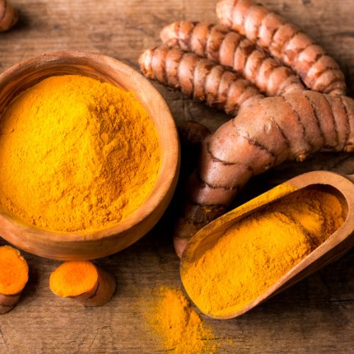 vibrant golden turmeric in wooden bowl